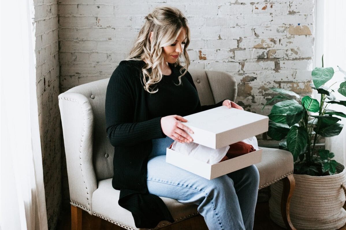 Woman unboxes a Kennedy Blue bridesmaid dress