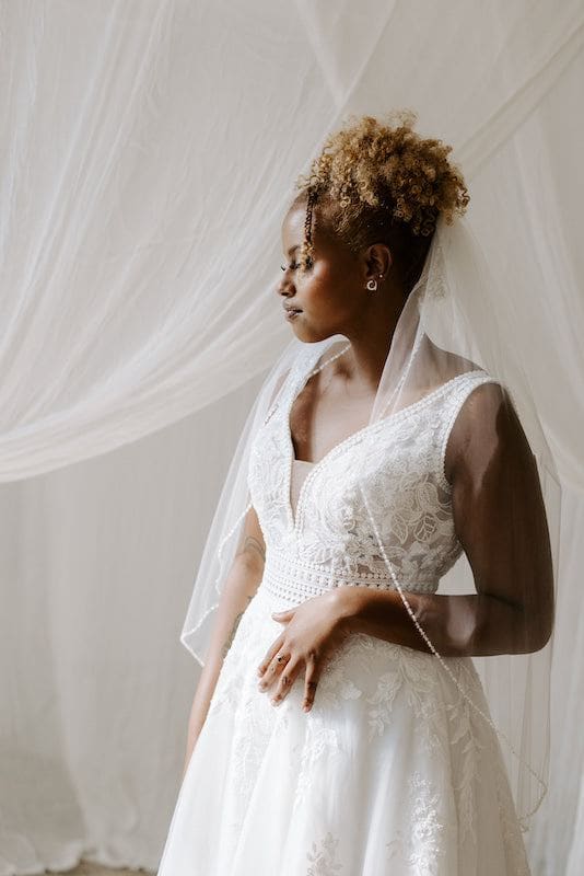 Bride wears Kennedy Blue beaded veil and earrings