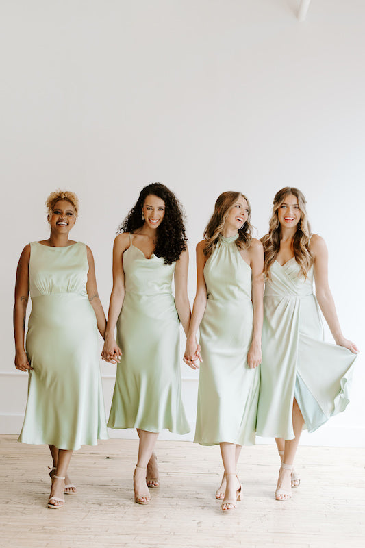 Group of bridesmaids wear Kennedy Blue satin dresses in dusty sage