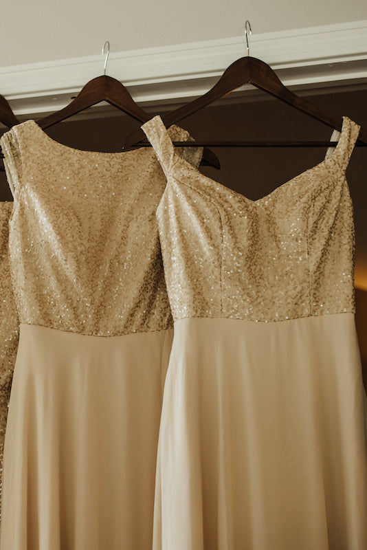 Kennedy Blue gold sequin bridesmaid dresses hanging up
