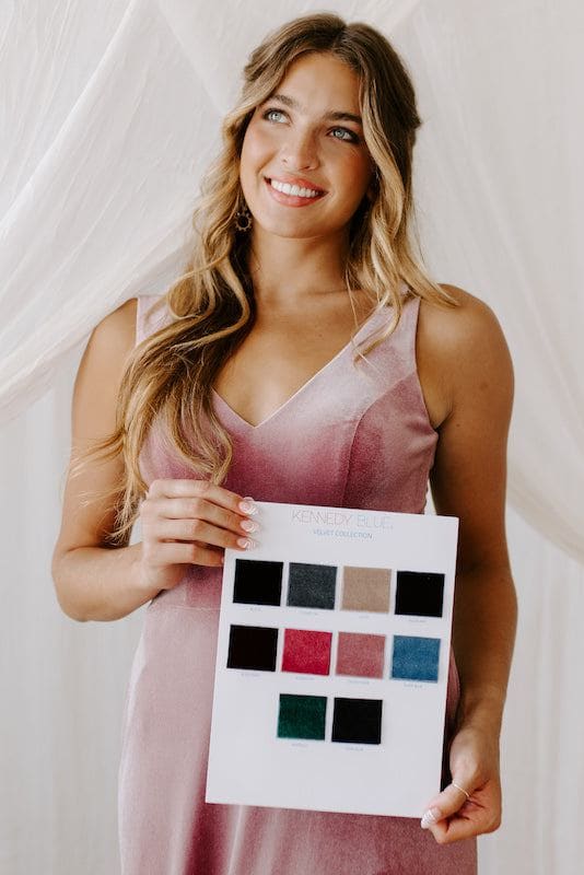 Kennedy Blue bridesmaid holds velvet swatches